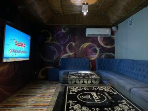 a living room with a couch and a tv at MAH Resort by Cocotel in Manila