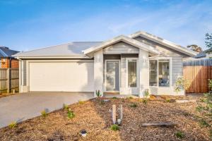 a house with a garage in front of it at The Seas at Phillip Island in Cowes