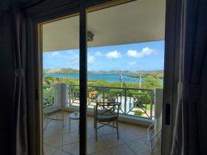 a room with a view of the ocean from a balcony at EliMar Bay View Studio in Culebra
