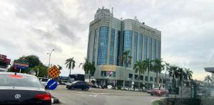 a large building with cars parked in front of it at D'Serina Homestay-3 bedroom 6 bed & free parking in Sungai Petani