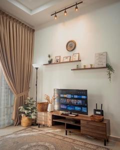 a living room with a large flat screen tv at De Jara Guesthouse Dungun for Malay in Dungun