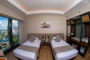 Sayarsan Hotel Yangon客房内的一张或多张床位