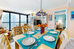 a dining room and living room with a table and chairs at Sea Watch 1110 in Ocean City