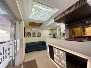 a lobby of a store with a blue couch at Hotel Hardik Palacio in Varanasi