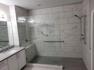 a white bathroom with a shower and a sink at 5 bed 3.5 baths in Las Vegas