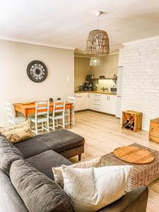 a living room with a couch and a table at At Leisure in Worcester