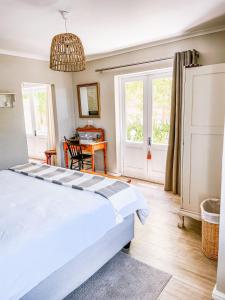 a bedroom with a large bed and a table at At Leisure in Worcester