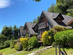 a house with a black roof at CIPRES Ecolodge & Spa in Frutillar
