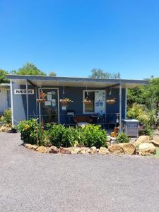 a blue building with flowers in front of it at Taroom Caravan & Tourist Park in Taroom