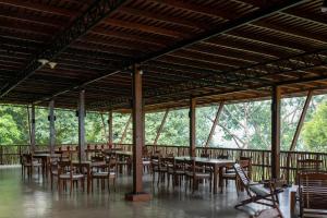 a group of tables and chairs in a pavilion at Birds Park Polgahawela in Egalla