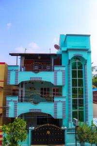 um grande edifício azul com uma grande janela em Dwaraka Guest House em Tiruvannamalai