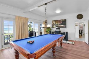 a pool table in the middle of a living room at Waterfront Entertainers Haven in Toukley
