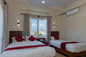 Postel nebo postele na pokoji v ubytování Hotel Sandalwood