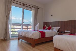 Postel nebo postele na pokoji v ubytování Hotel Sandalwood