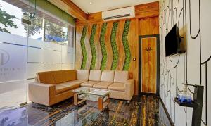 a living room with a couch and a tv at Treebo Trend Prime Grand, Andheri in Mumbai