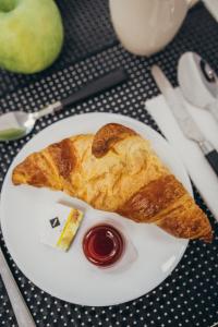 a white plate with a piece of bread and ketchup at RUBO Hotel in Shumen