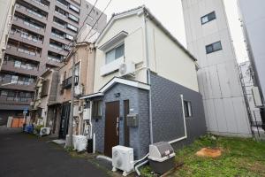 an apartment building with toilets outside of it at Cozy Room in東京浅草二階建の一軒家 in Tokyo