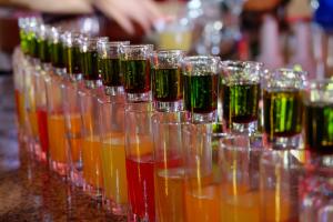 a row of glasses filled with different colored liquids at Nest Resort in Pagudpud