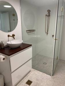 a bathroom with a glass shower and a sink at Fabulous Sea Views in the heart of Surfers in Gold Coast