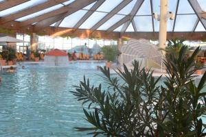 a swimming pool with people in the water at Pension Hanna in Bad Wilsnack