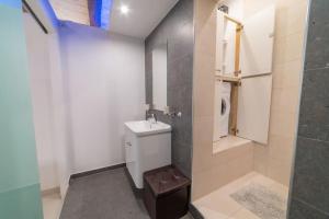 a bathroom with a toilet and a sink and a shower at JBO- Joette's Bliss Oasis in Valletta