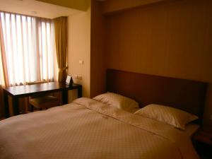 Postel nebo postele na pokoji v ubytování AJ Residence 安捷國際公寓酒店