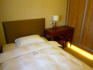 Postel nebo postele na pokoji v ubytování AJ Residence 安捷國際公寓酒店