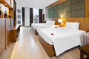 Postel nebo postele na pokoji v ubytování Eden Star Saigon Hotel