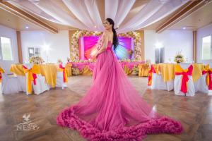 a woman in a pink dress dancing in a ballroom at Nest Resort in Pagudpud