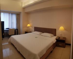 Postel nebo postele na pokoji v ubytování AJ Residence 安捷國際公寓酒店