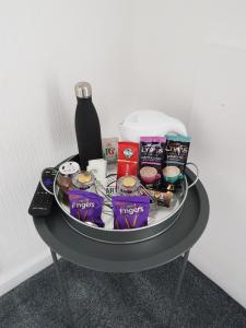 a table with a tray of food and a bottle on it at The Cedars Hotel in Lincolnshire