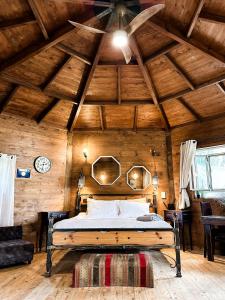 a bedroom with a bed in a wooden ceiling at Crimson View in Moshav Ramot