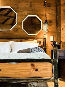 a bedroom with a bed with a wooden wall at Crimson View in Moshav Ramot