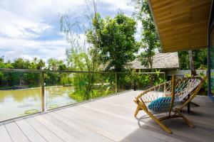 a wooden bench sitting in front of a pool of water at Island Escape by Burasari - SHA Extra Plus in Phuket