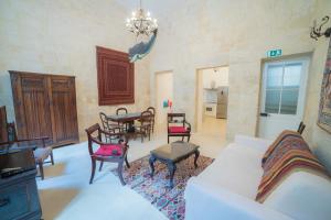 a living room with a couch and chairs and a table at HT1- Heritage Treasure 1 in Valletta