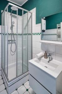 a bathroom with a shower and a sink at cozy Apartment -Traminer- mit MagentaPlus in Meißen