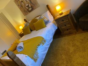 a bedroom with a large bed with yellow pillows at The terrace in York