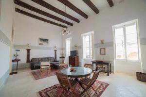 a living room with a table and chairs at HT3- Heritage Treasure by Vallettastay in Valletta