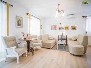a living room with a couch and a table and chairs at Holiday Home Boltar in Varaždin