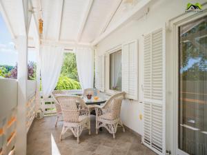 a porch with a table and chairs and a window at Holiday Home Boltar in Varaždin