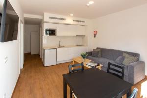a living room with a couch and a table at Loft Matilde by Grupo Matilde in Las Palmas de Gran Canaria