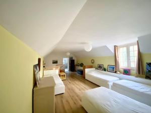 a large living room with two beds and a couch at Maison de famille près de la mer in Bénodet