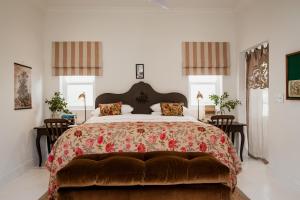 a bedroom with a large bed and two windows at Dorp Hotel in Cape Town