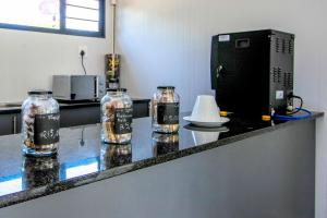 three glass jars sitting on a counter in a kitchen at SleepOver Kruger Gate in Skukuza