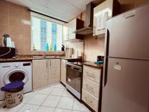 a kitchen with a refrigerator and a dishwasher at SKY NEST HOLIDAY HOMES 1 bedroom Apartment dubai marina 2903 in Dubai