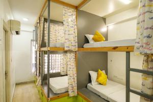 a dorm room with bunk beds and a window at Moustache Hostel, Jaipur in Jaipur