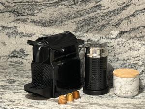 a black toaster and a container on a table at Melbourne CBD Apt with Free Car Park Ocean View in Melbourne