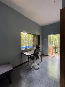 an office with a desk and a chair in a room at Shobha Niwas in Nandgaon