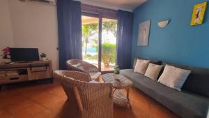 a living room with a couch and chairs and a television at Porto Antigo 2 BeachFront in Santa Maria