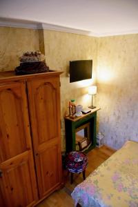 a bedroom with a bed and a dresser and a television at Sunny ap in the citycentre in Budapest